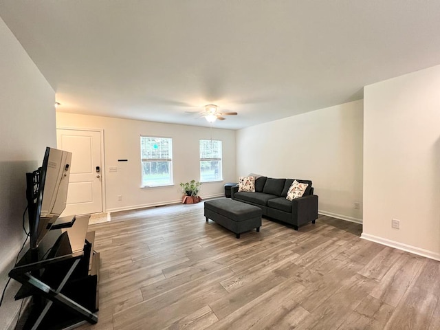 living room with light hardwood / wood-style floors and ceiling fan