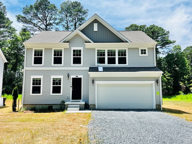 view of front facade with a garage and a front lawn