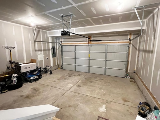 garage featuring electric panel and a garage door opener