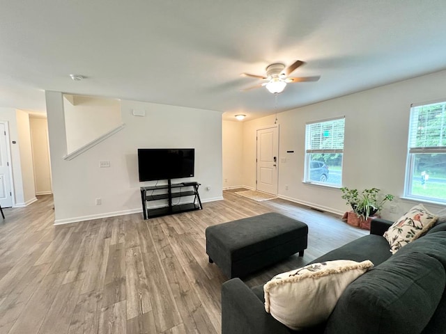 living room featuring ceiling fan and light hardwood / wood-style flooring