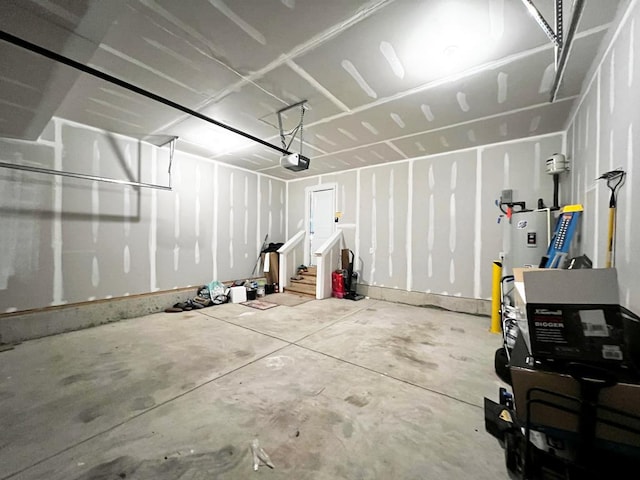 garage featuring a garage door opener and water heater