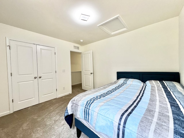 bedroom with dark colored carpet and a closet