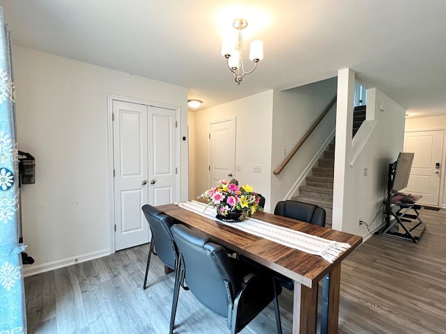 dining space featuring dark hardwood / wood-style floors and a chandelier