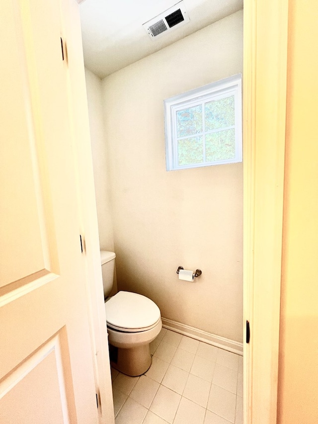 bathroom with tile patterned flooring and toilet