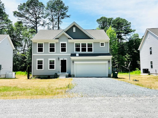 view of front of house featuring a garage and a front lawn