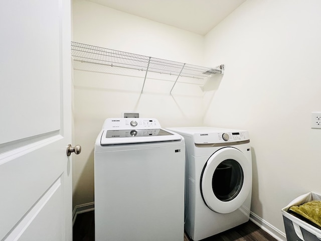 laundry room featuring dark hardwood / wood-style flooring and separate washer and dryer