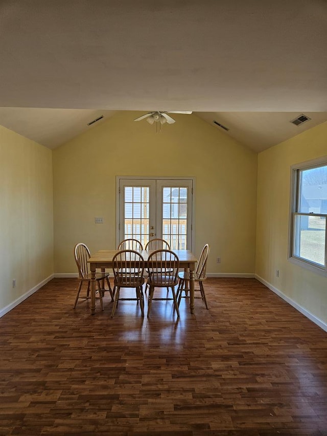 dining room featuring visible vents, french doors, dark wood-style flooring, and vaulted ceiling