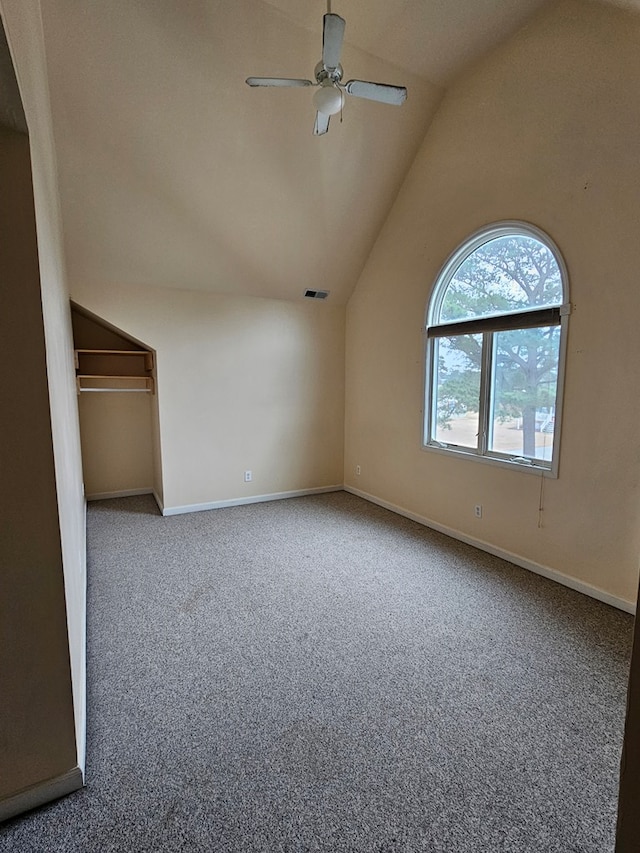 interior space with vaulted ceiling, ceiling fan, and carpet floors