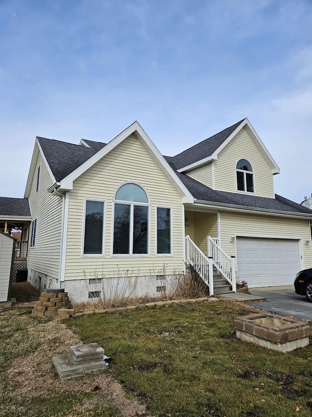 traditional home featuring a front yard, a garage, driveway, and crawl space