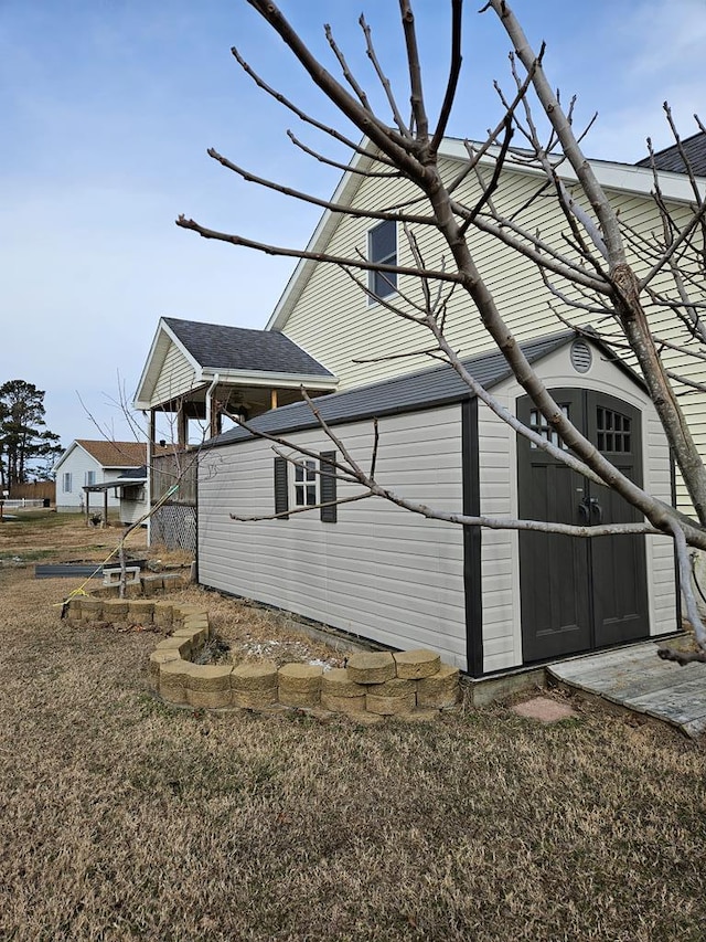 view of side of home with a lawn