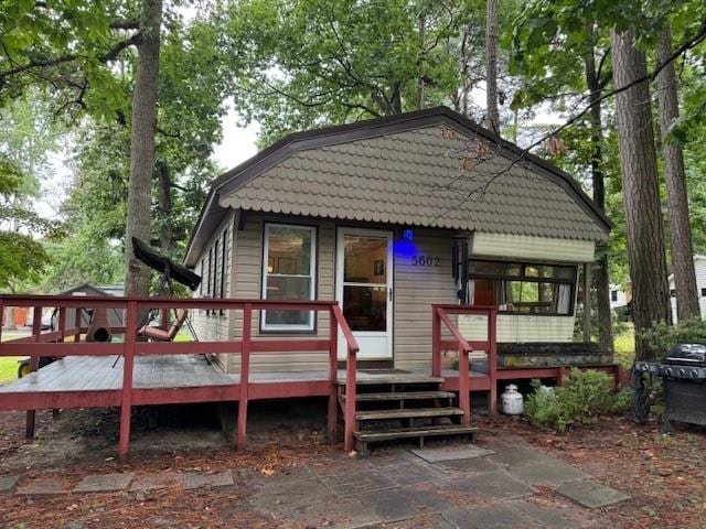 rear view of house with a wooden deck