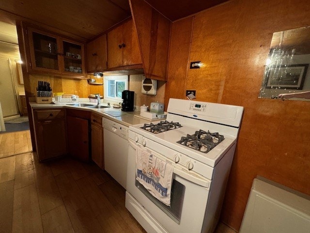 kitchen featuring white appliances, dark hardwood / wood-style floors, and sink