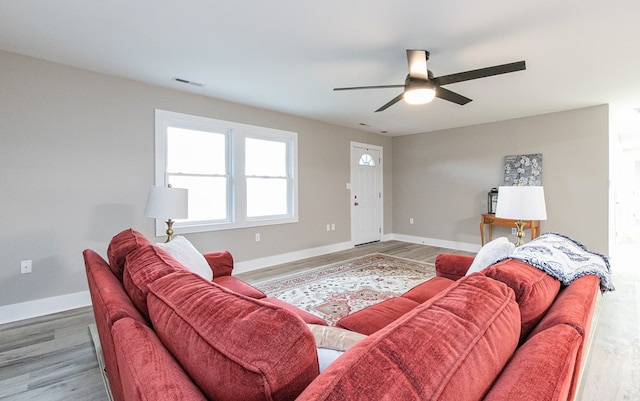 living room featuring hardwood / wood-style floors and ceiling fan