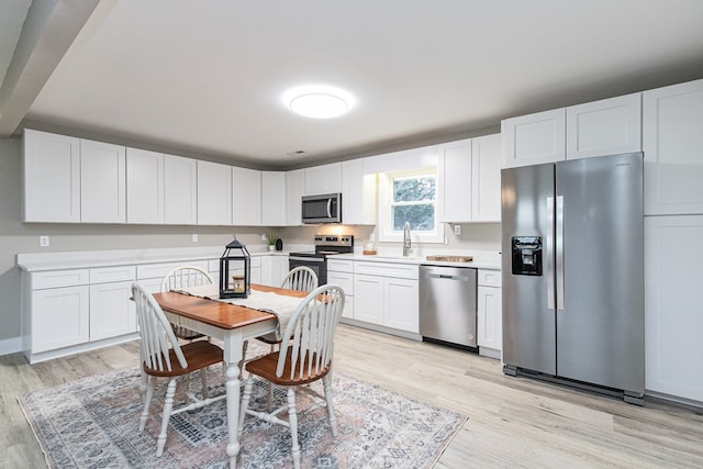 kitchen with appliances with stainless steel finishes and white cabinetry