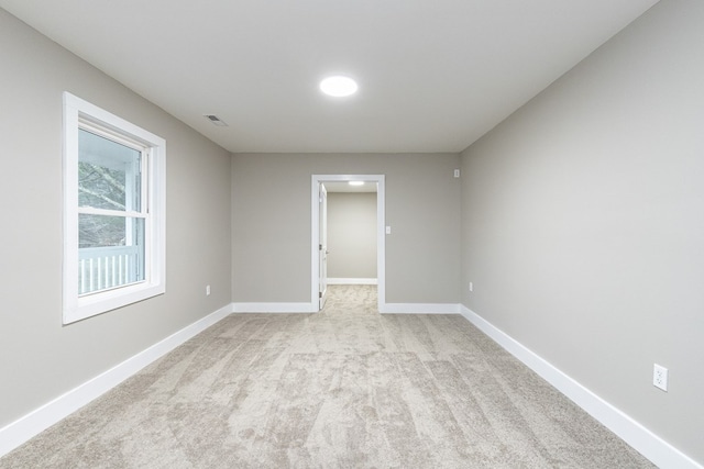 empty room with light colored carpet