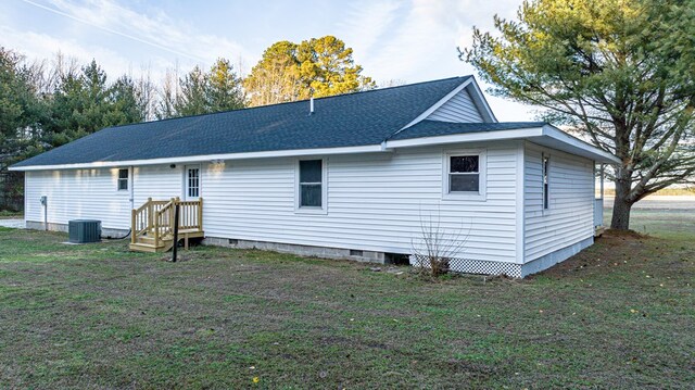 rear view of property featuring a lawn