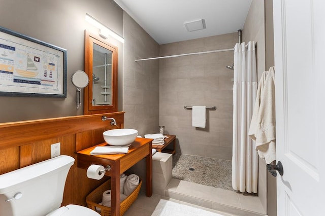 full bath with vanity, a shower stall, toilet, and tile patterned floors