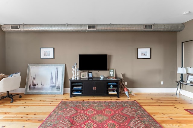 living room featuring baseboards and wood finished floors