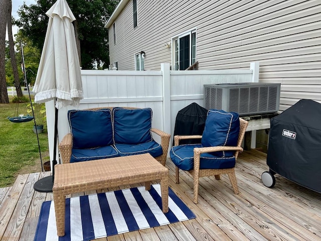 wooden deck featuring central air condition unit and grilling area