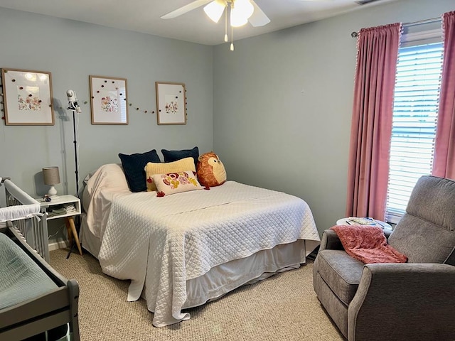 bedroom with light carpet and ceiling fan