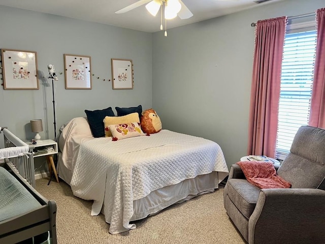 bedroom featuring ceiling fan and light carpet