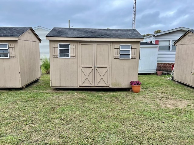 view of outbuilding featuring a yard