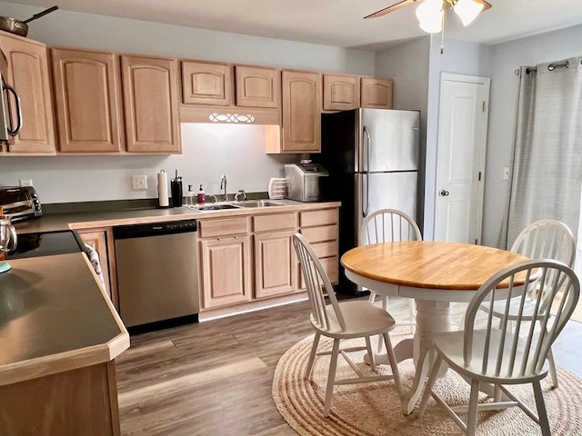 kitchen featuring light brown cabinetry, sink, hardwood / wood-style floors, and appliances with stainless steel finishes