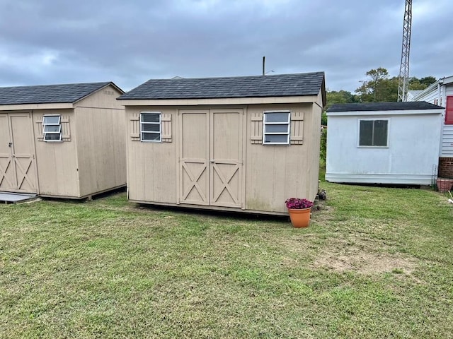 view of outbuilding featuring a lawn