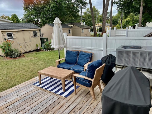 wooden terrace featuring a lawn, a storage unit, central AC unit, and outdoor lounge area