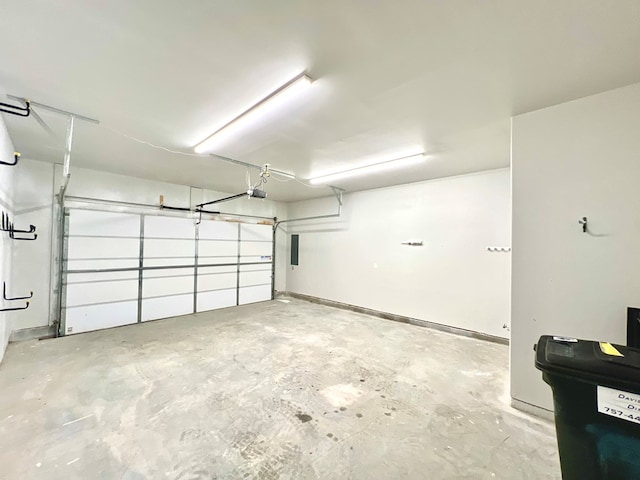 garage featuring electric panel and a garage door opener