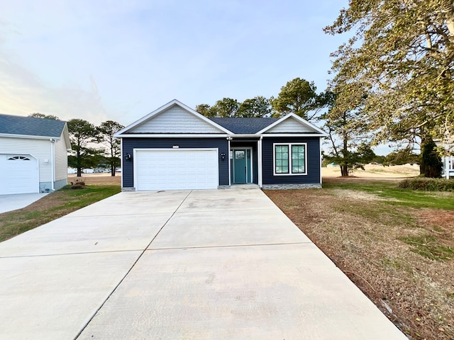 3102 Cutter Ct, Greenbackville, VA 23356 - view of front facade with concrete driveway, a garage, and a front lawn