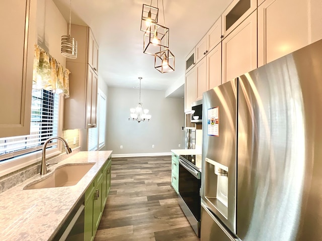 kitchen with appliances with stainless steel finishes, sink, a notable chandelier, dark hardwood / wood-style floors, and green cabinets