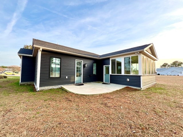 view of front of home featuring a sunroom, a patio area, and a front lawn