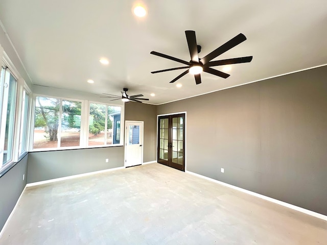 spare room with ceiling fan and french doors