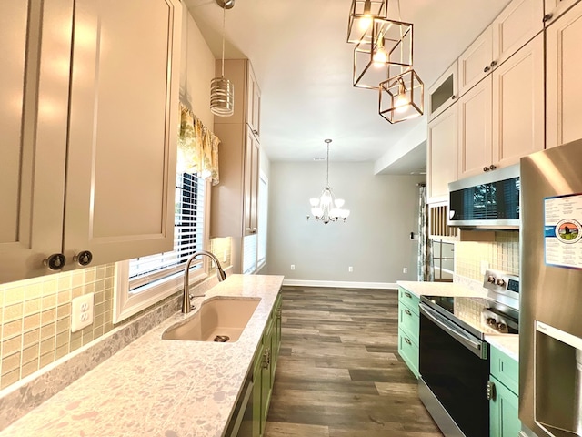 3102 Cutter Ct, Greenbackville, VA 23356 - kitchen with appliances with stainless steel finishes, a chandelier, decorative backsplash, dark wood-type flooring, and light stone counters