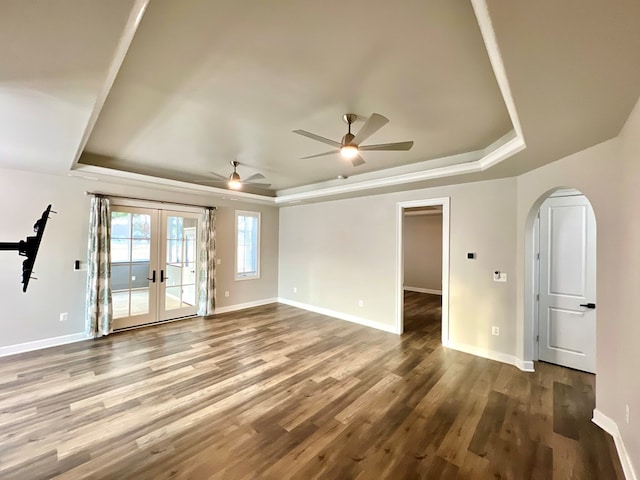 unfurnished room featuring french doors, a raised ceiling, and ceiling fan