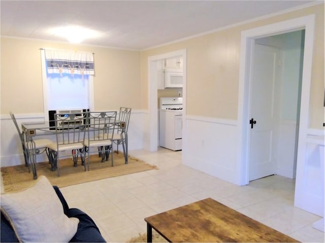 dining space with light tile patterned floors and crown molding