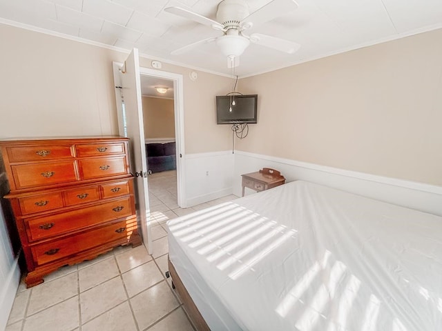 bedroom featuring light tile patterned floors, ceiling fan, and ornamental molding