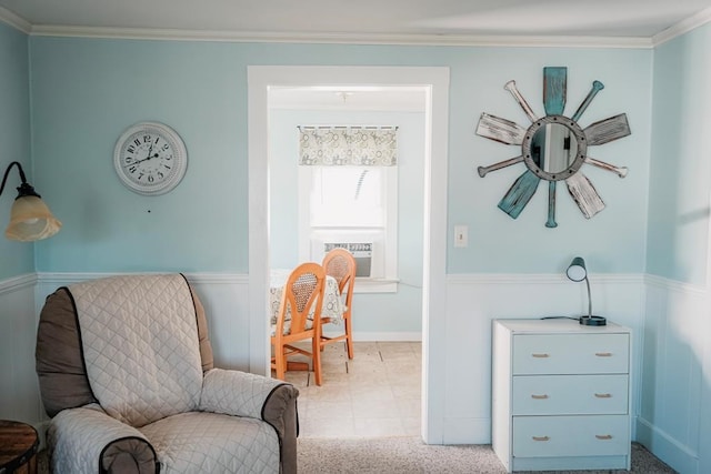 sitting room with ornamental molding, cooling unit, wainscoting, and carpet flooring