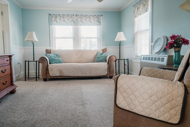 interior space featuring a wainscoted wall, radiator, ornamental molding, carpet flooring, and ceiling fan