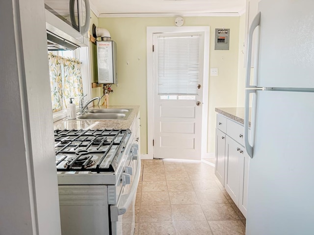 kitchen featuring light countertops, water heater, ornamental molding, a sink, and white appliances