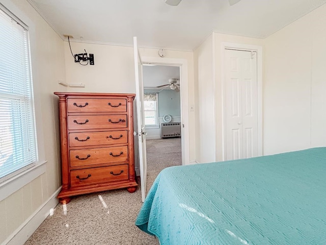 bedroom featuring carpet floors, ornamental molding, and a closet