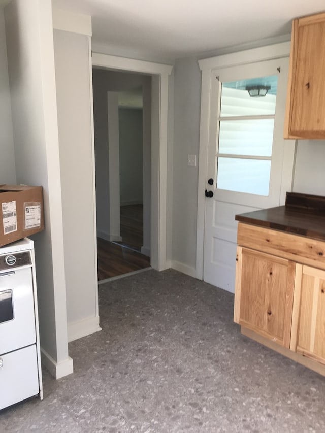 kitchen featuring light brown cabinetry and washer / clothes dryer