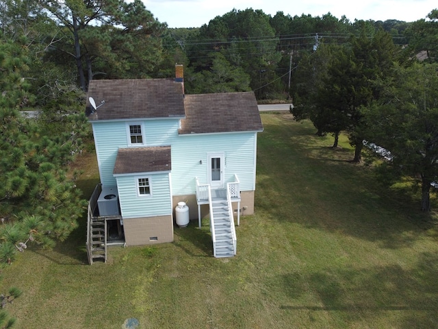 back of house with a lawn