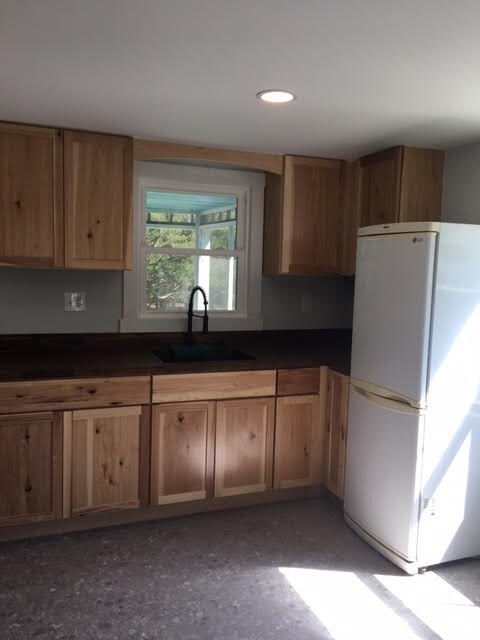 kitchen featuring white refrigerator and sink