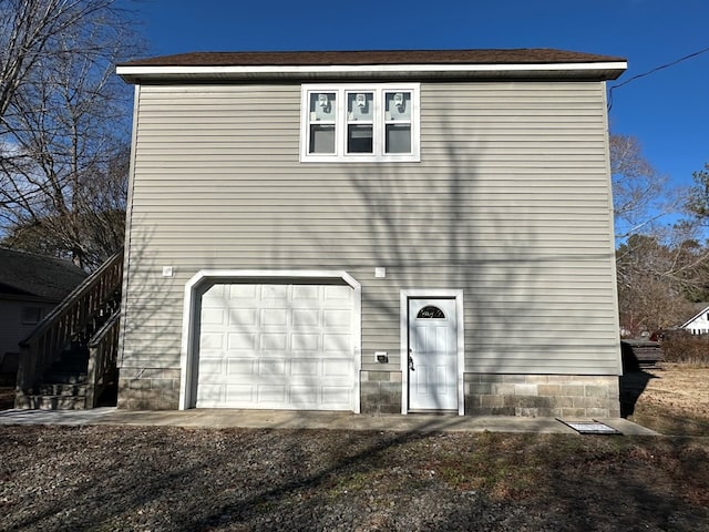 rear view of house featuring a garage