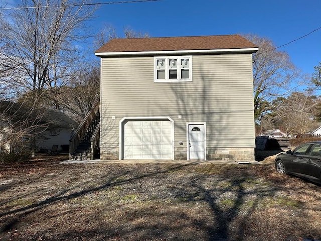 back of house featuring a garage