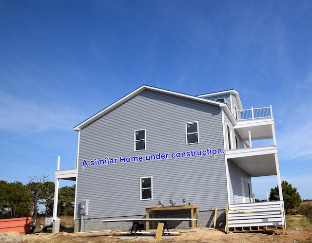 view of side of home with a balcony