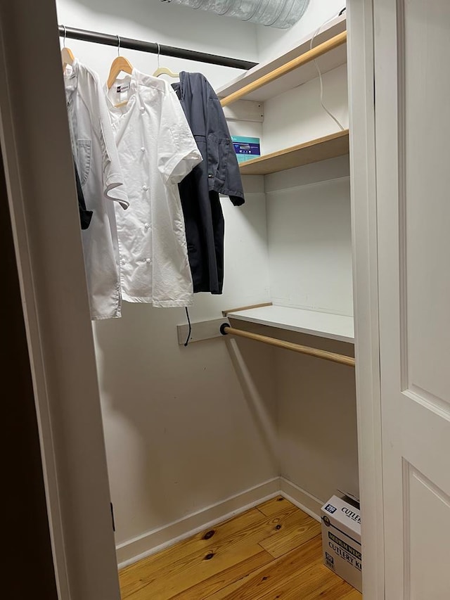 walk in closet featuring wood finished floors