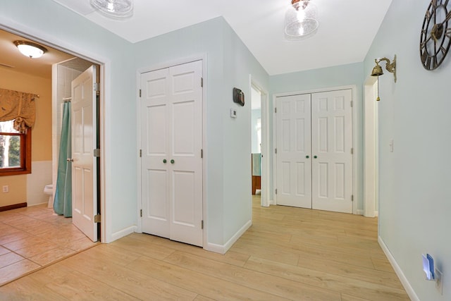 entrance foyer with light wood-type flooring and baseboards